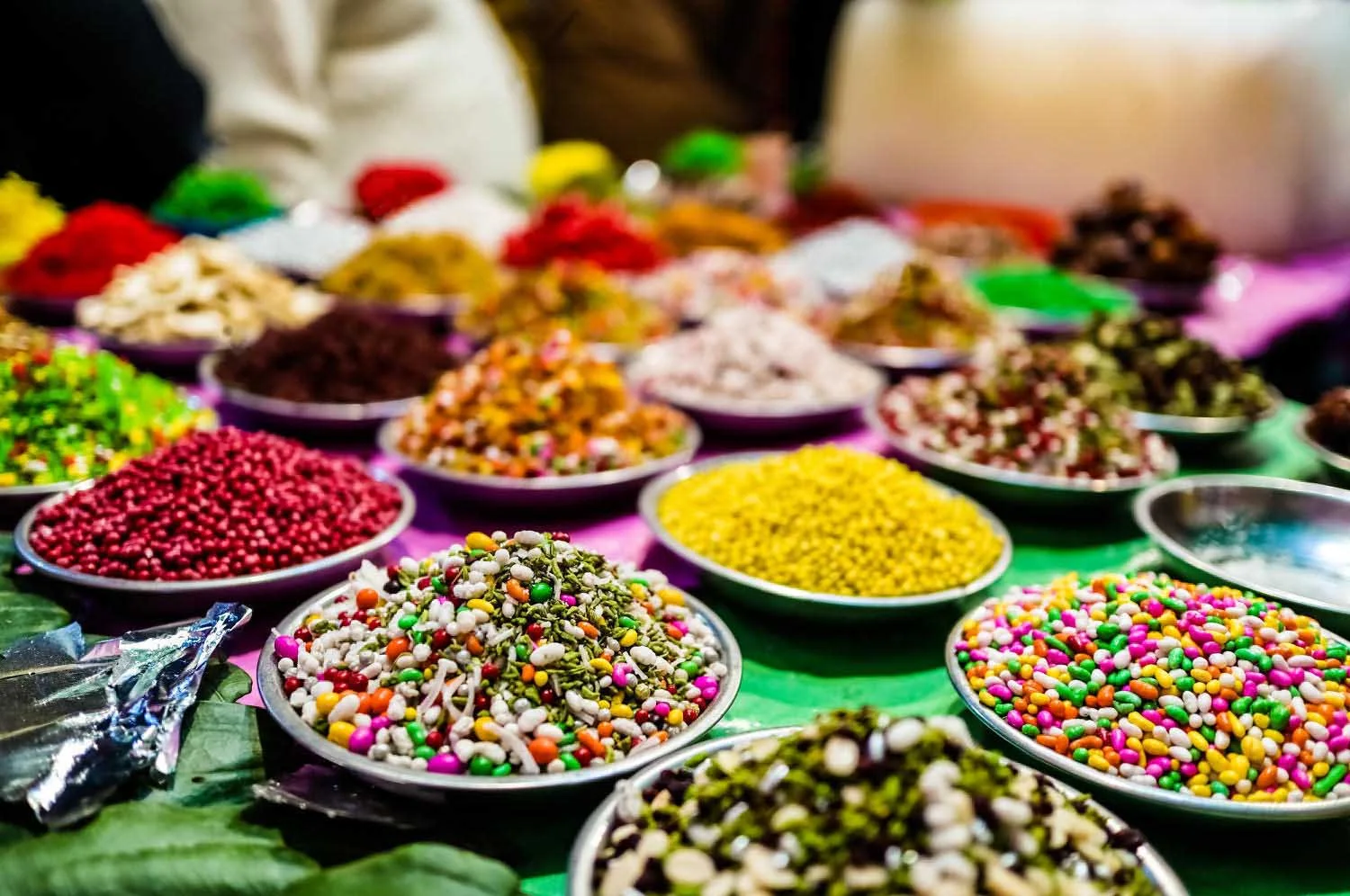 Bowls of colourful sweet and roasted mukhwas at an Indian market stall